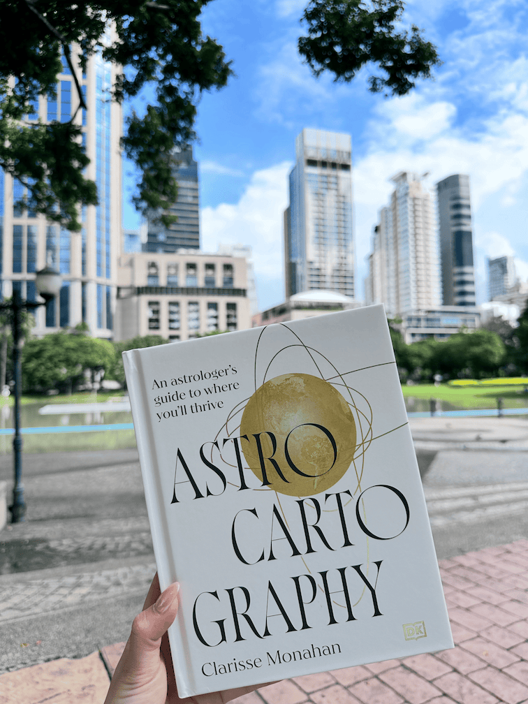 Astrocartography book with cats outdoors