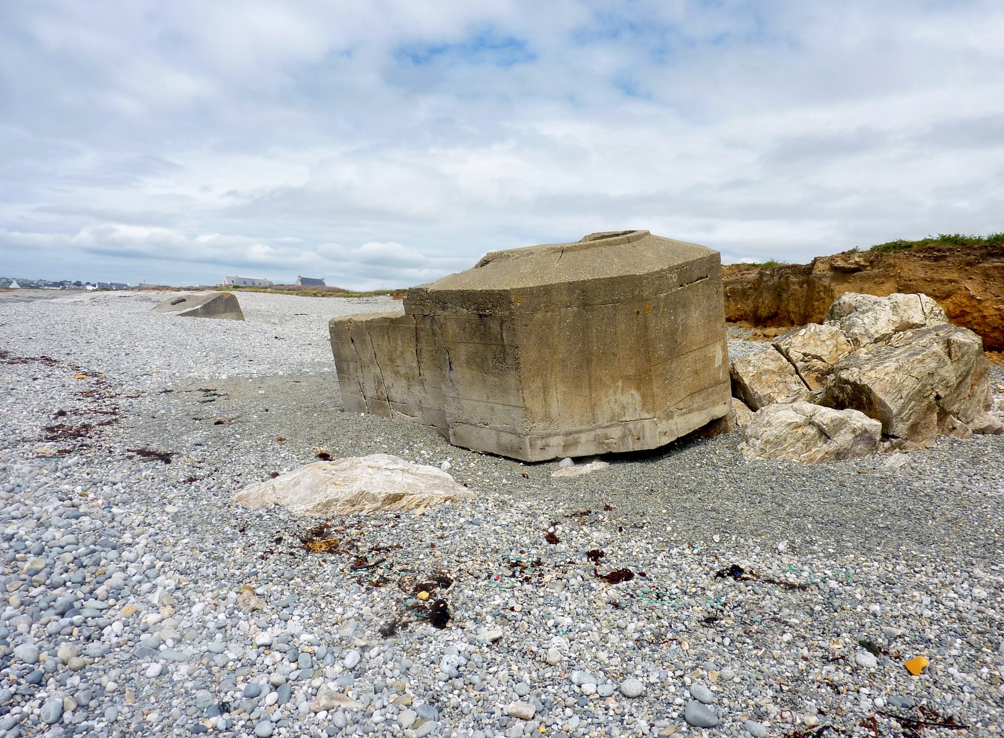A lone concrete blockhaus standing on an Atlantic shoreline